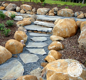 Cut stone steppers with informal stone garden border